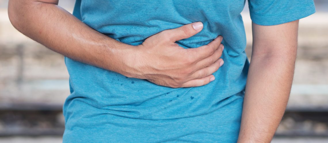 sick man suffers from stomach ache, diarrhea, constipation, indigestion, flatulence; food poisoning