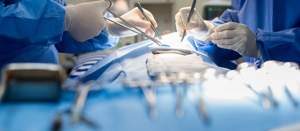 Asian doctor and an assistant in the operating room for surgical venous vascular surgery clinic in hospital.